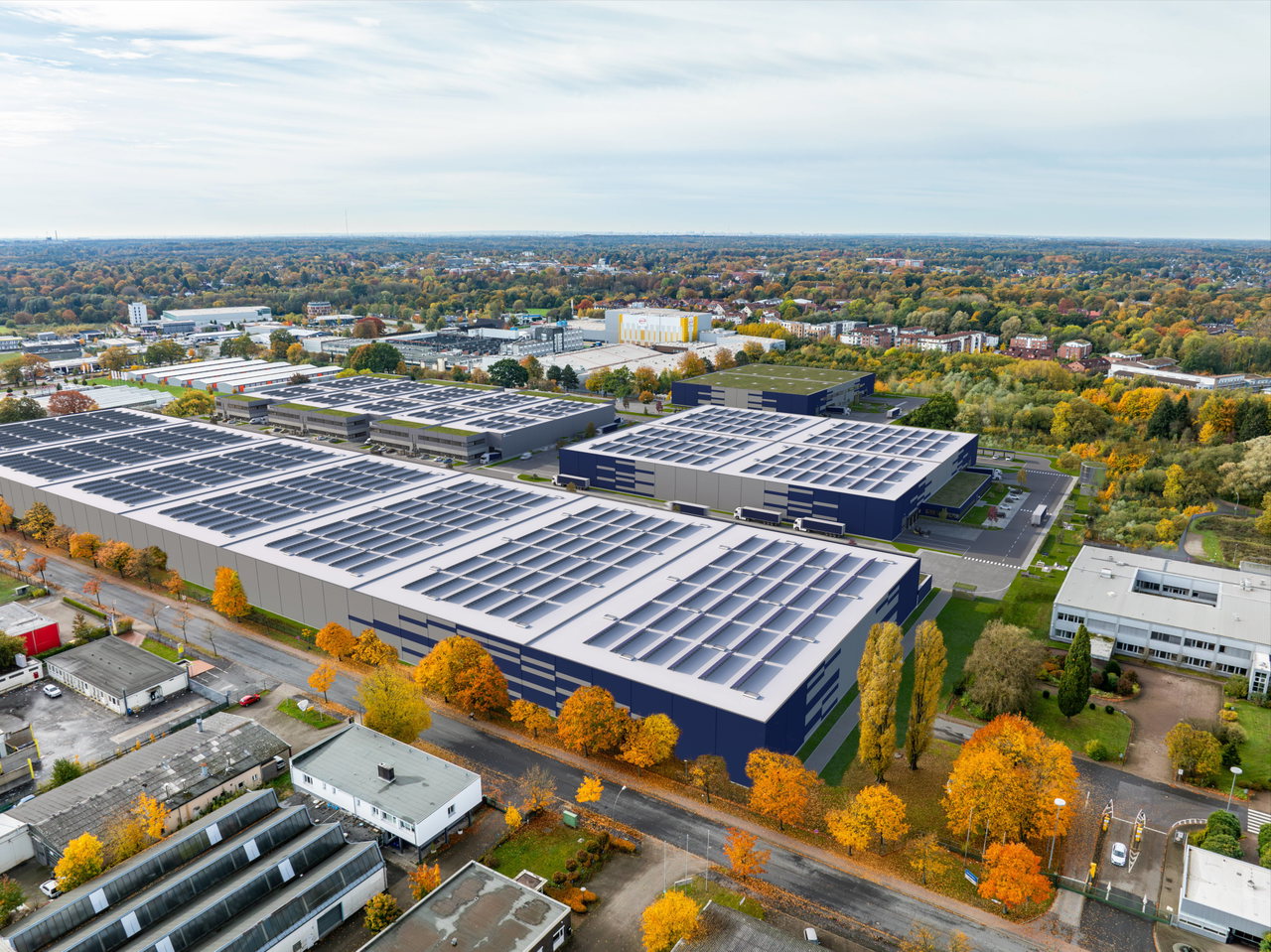 Visualisierung aus der Luft: Logistik- und Gewerbehallen mit Solardächern zwischen herbstlichen Bäumen