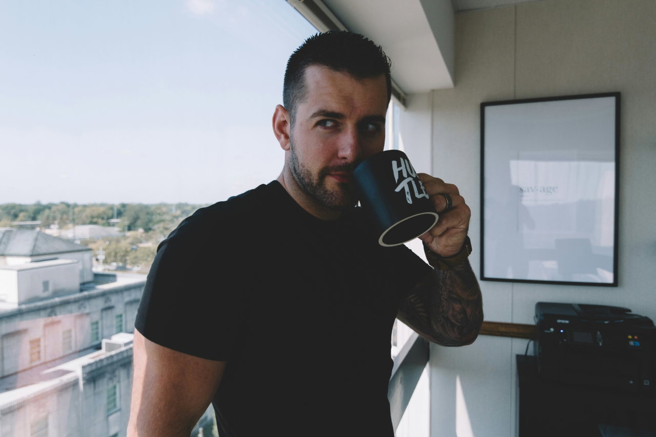 person holding cup-Vw6xNHpyXuw-unsplash