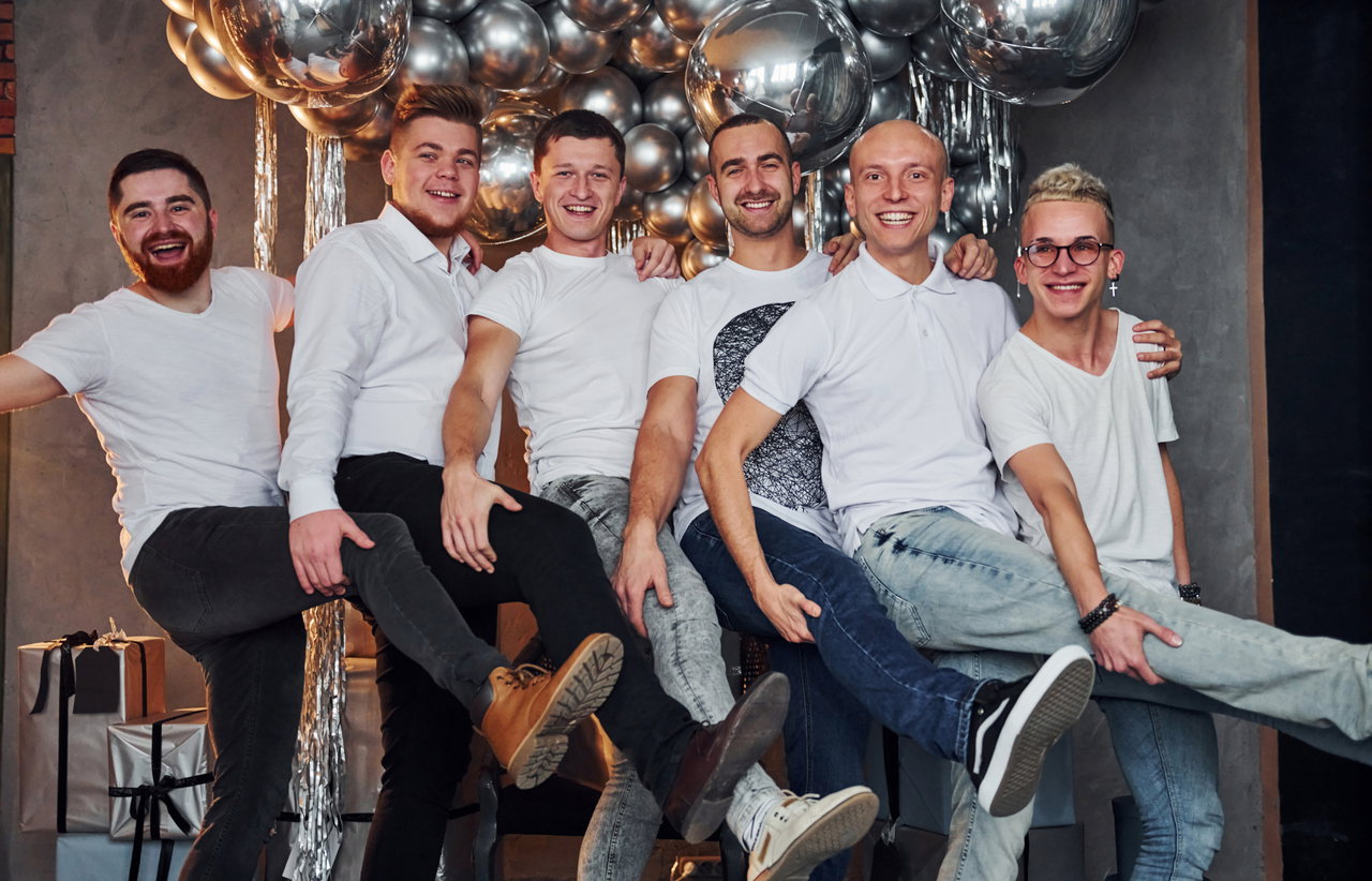 group-cheerful-men-standing-together-christmas-decorated-room-posing-camera