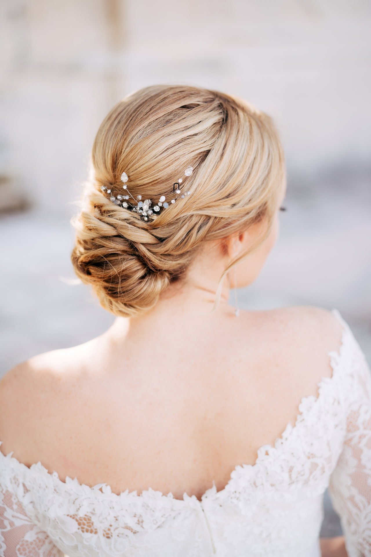 blonde-bride-with-beautiful-hairstyle-dress-with-bare-shoulders-back-view