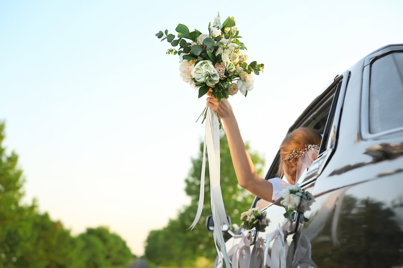beautiful-young-bride-holding-bouquet-decorated-car