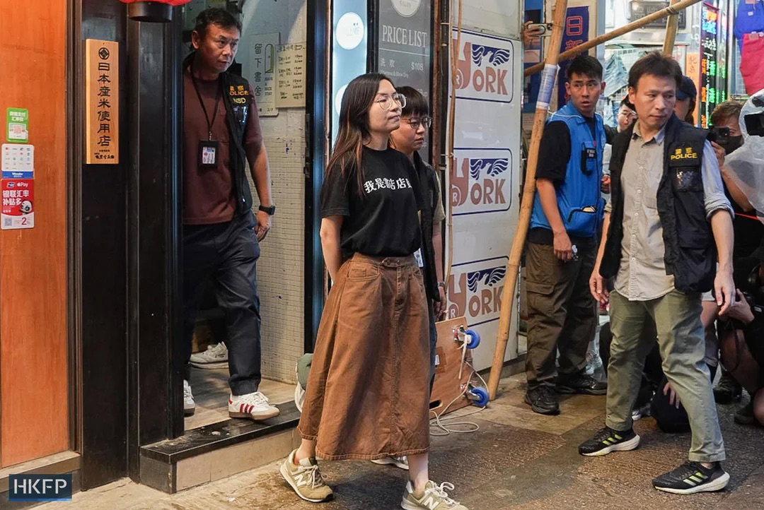 a-woman-is-escorted-away-from-have-a-nice-stay-independent-v0-cus83bvvpidh1