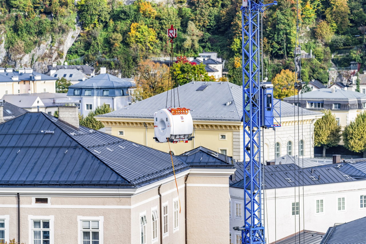 Ein MRT hängt am Baukran hoch über den Dächern der Salzburger Altstadt