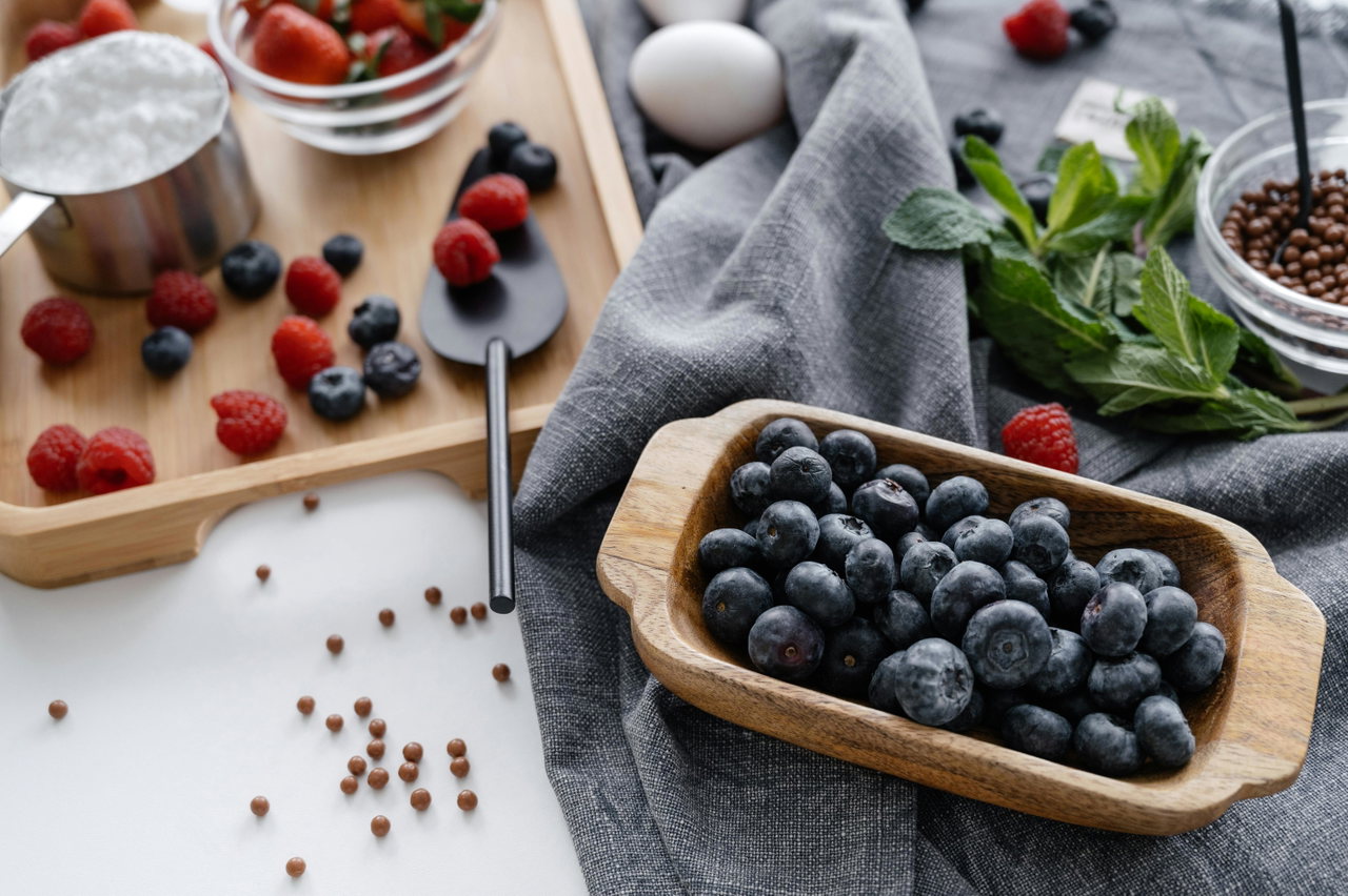 Zutaten für die Beerentorte: Blaubeeren, Himbeeren, Erdbeeren, Mehl und Schokoladenperlen