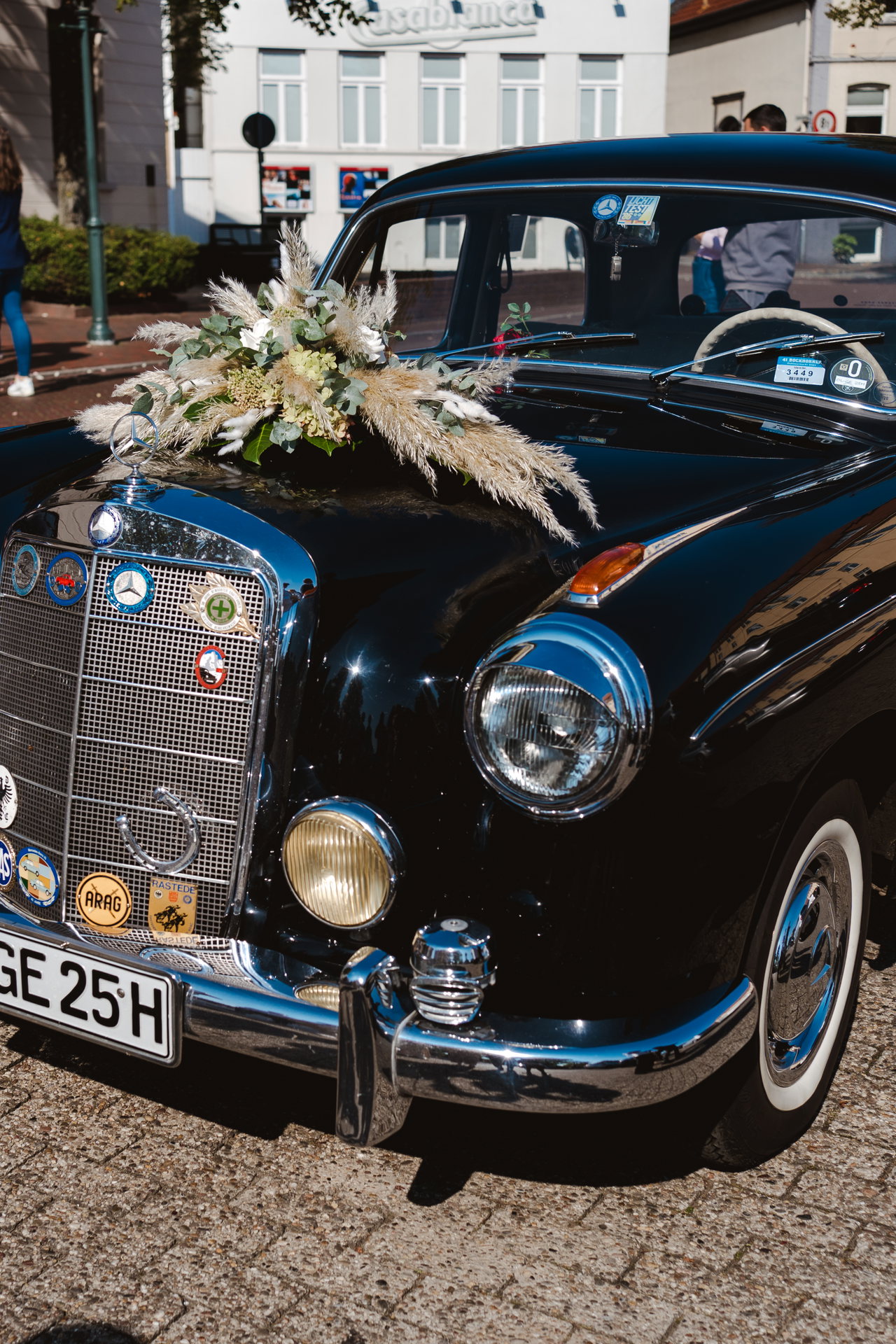 Schwarzer Oldtimer mit Blumengesteck auf der Motorhaube